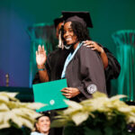 Student graduating receiving diploma